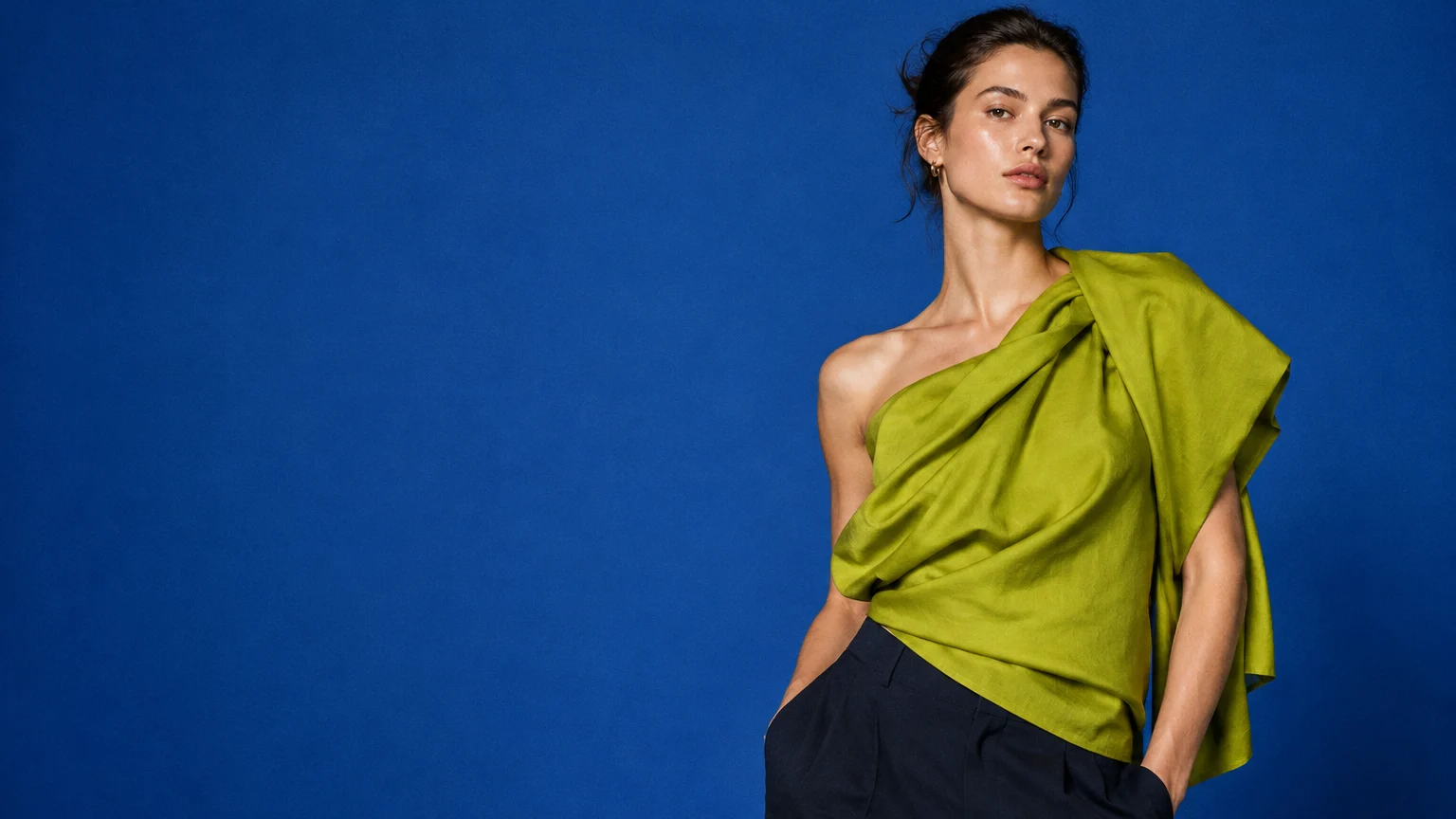 Fashion campaign illustration: chartreuse sculptural top against a cobalt studio backdrop